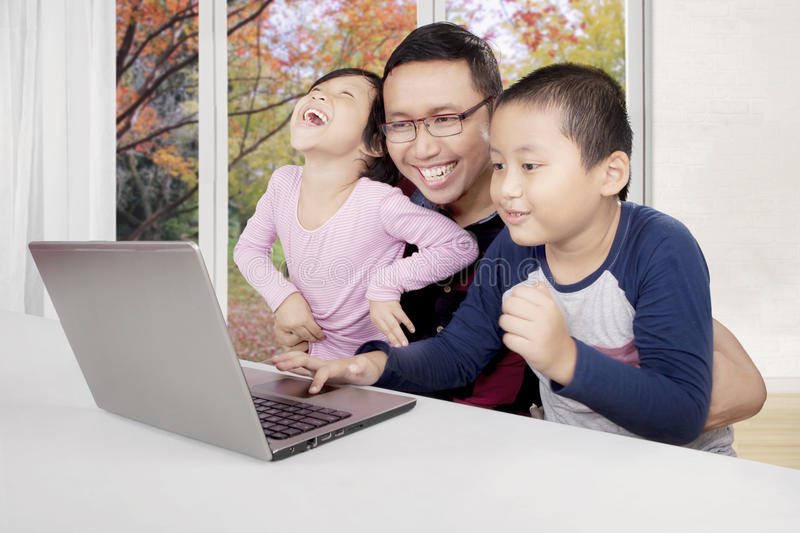 asian-father-his-children-using-laptop-picture-teaching-to-use-computer-laughing-together-home-98707036 Number 2