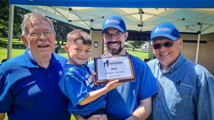 Cameron and son, Lincoln, with Fred and Ron