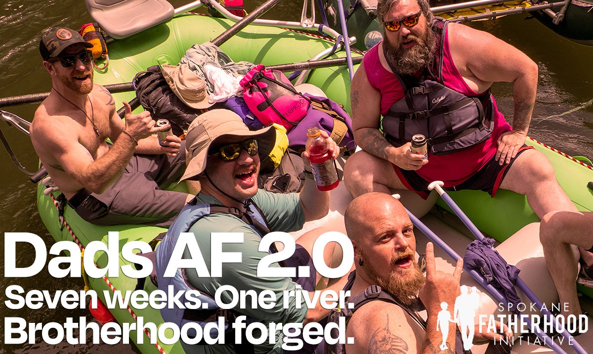 Four Dads AF alumni laughing and celebrating on a raft on the Clark Fork River — text overlay reads "Dads AF 2.0: Seven weeks. One river. Brotherhood forged." with the Spokane Fatherhood Initiative logo.
