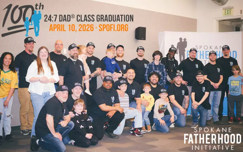 Graduates and families of SpoFI's 100th 24-7 Dad class with the Spokane Fatherhood Initiative 100th graduation seal, April 10, 2026