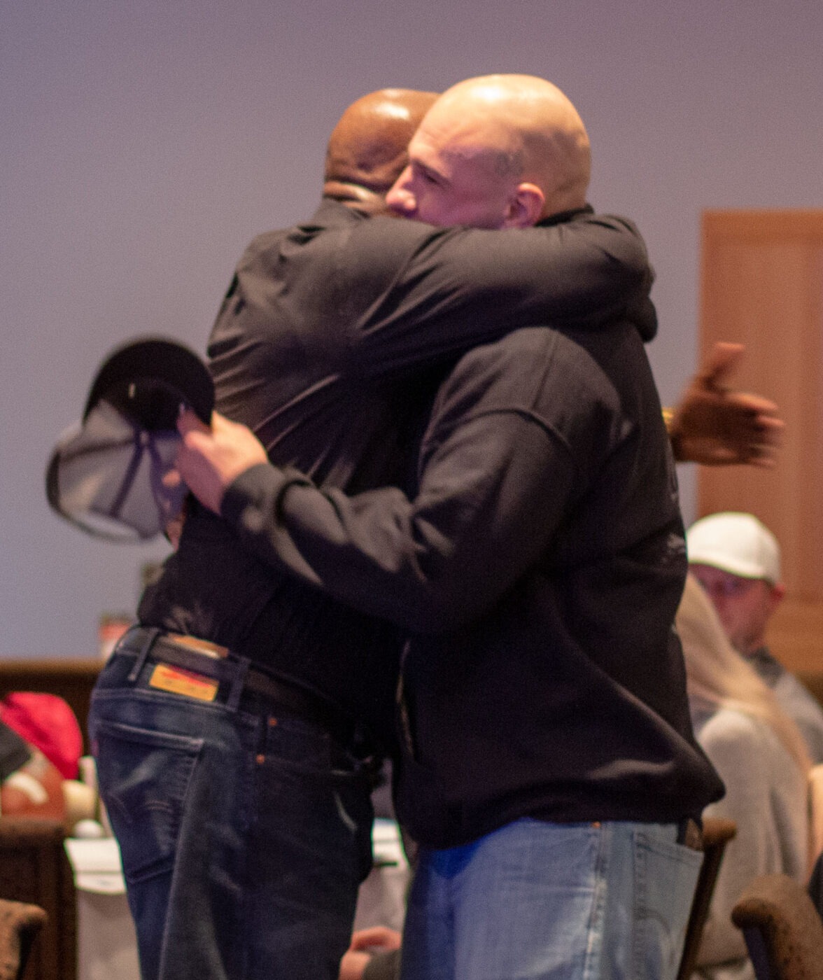 What reconciliation looks like: SpoFI's 100th graduation and the fathers who made it possible 3 Marvin Charles and Matt White embrace at the end of SpoFI's first 24-7 Dad graduation ceremony, 2018