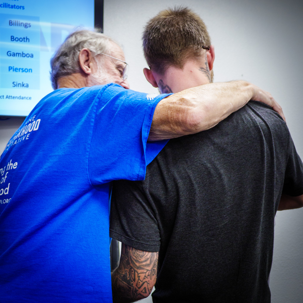 Morris (Tex) Sutton 24:7 Dad AM Co-Facilitator/Observer​ embraces graduate Dantae Billings
