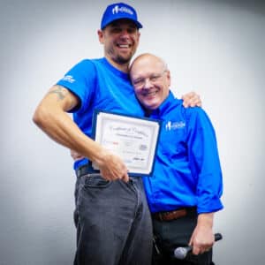 Christopher Gordon and Ron Hauenstein celebrate with a hug and a smile that could light up the room.
