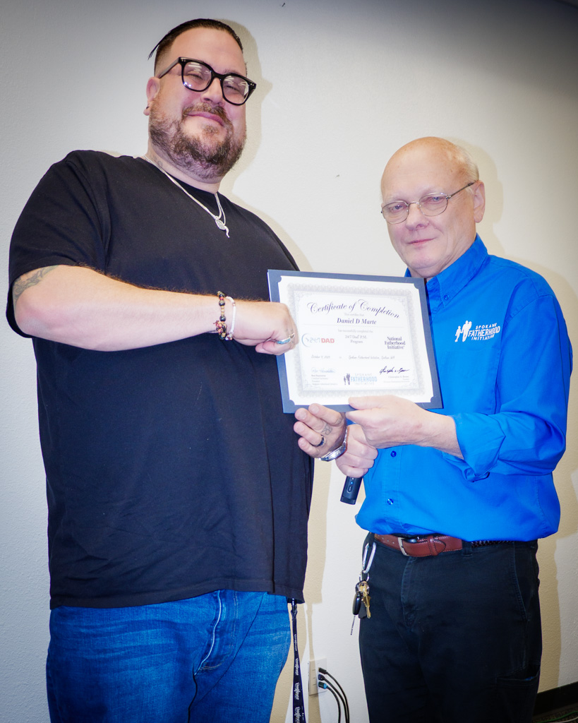 Graduate Daniel Marie celebrates completion of the 24/7 Dad program with Ron Hauenstein