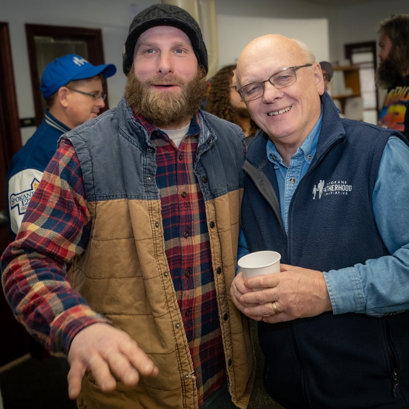 Ten years of changed dads: SpoFI celebrates a decade of transforming fathers and families 12 Bryan Mochel SpoFI alumni and supporter with founder Ron Hauenstein at 10th anniversary celebration January 2026 Spokane