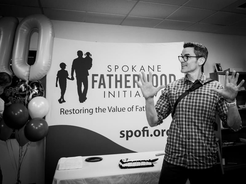 Ten years of changed dads: SpoFI celebrates a decade of transforming fathers and families 6 Lawrence Long SpoFI alumni digital strategy specialist at 10th anniversary celebration gesturing about future growth Spokane January 2026