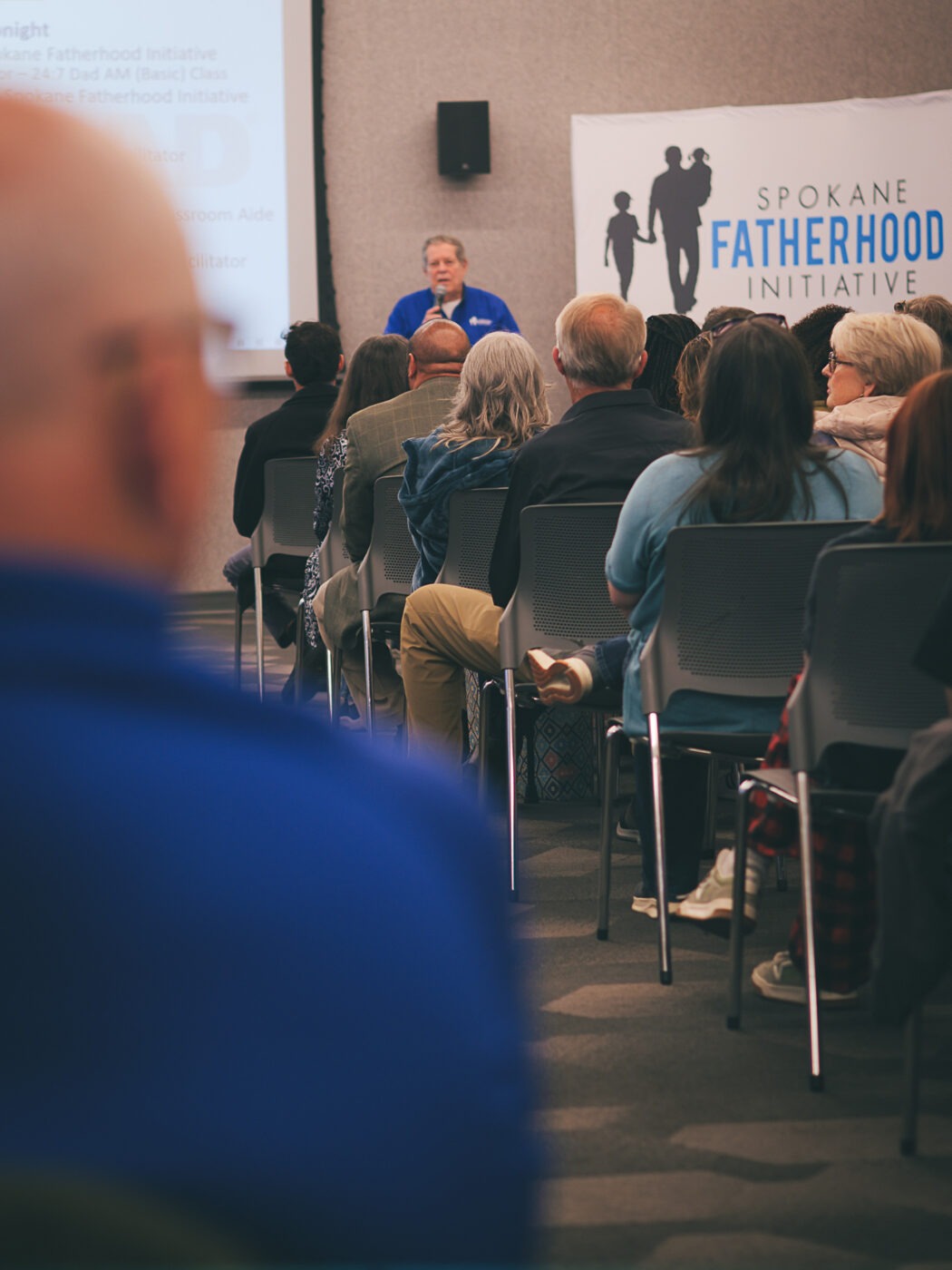 SpoFI's 100th 24-7 Dad class graduation recap: a night eight years in the making 4 Fred Dent, Board Vice President of Spokane Fatherhood Initiative, addresses a full room at the 100th 24-7 Dad class graduation at The Hive in Spokane, April 10, 2026