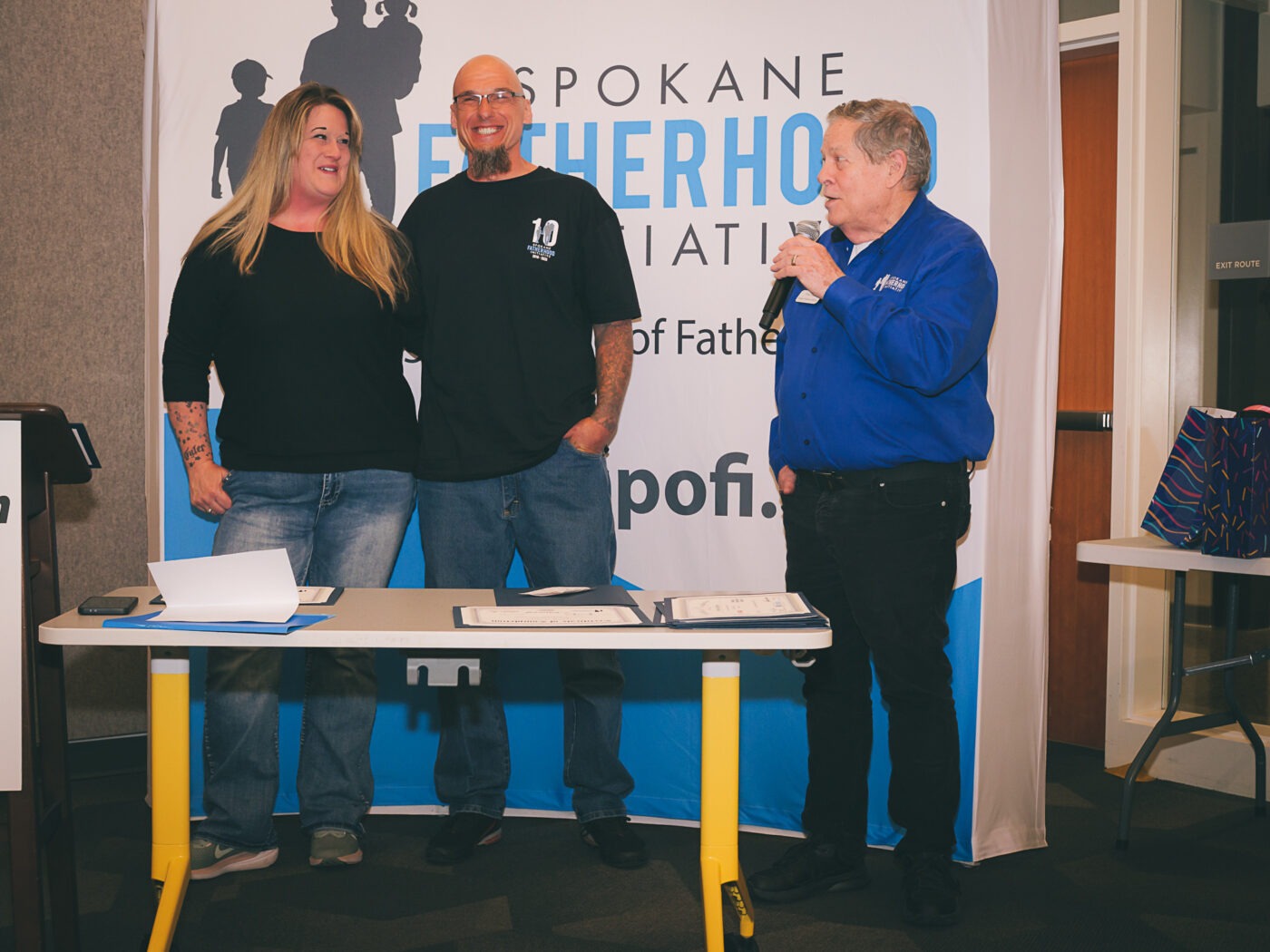 SpoFI's 100th 24-7 Dad class graduation recap: a night eight years in the making 5 Matt White, graduate of SpoFI's very first 24-7 Dad class in 2018, and his wife Brandi receive recognition at SpoFI's 100th graduation ceremony, April 10, 2026