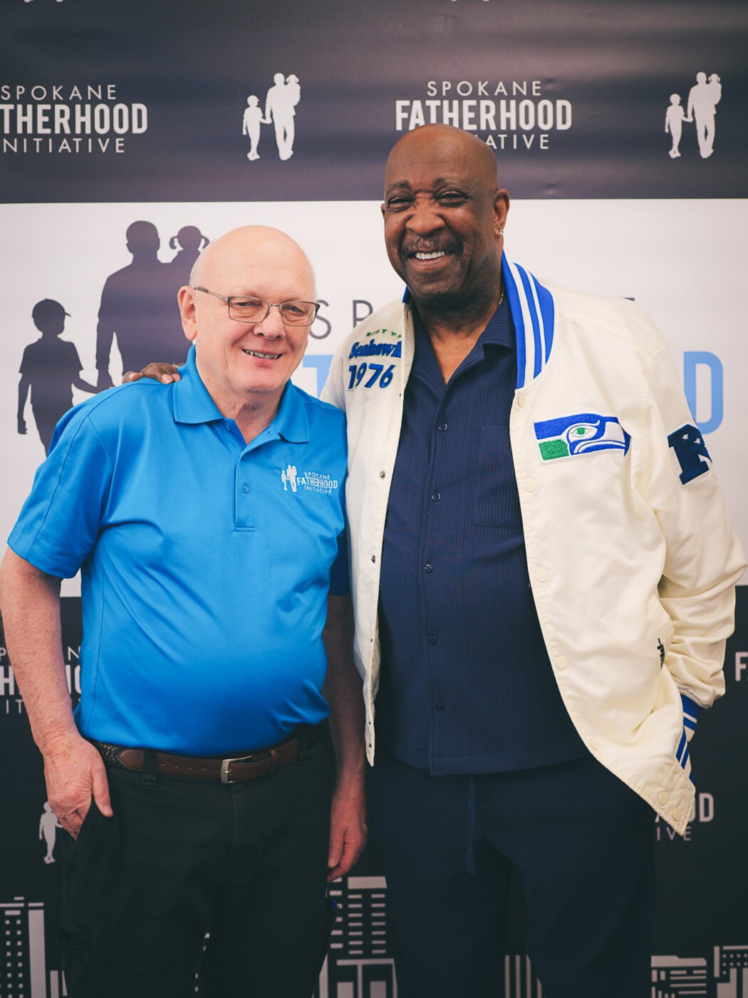 SpoFI's 100th 24-7 Dad class graduation recap: a night eight years in the making 3 Ron Hauenstein, Executive Director of Spokane Fatherhood Initiative, with Marvin Charles of DADS Seattle at the step-and-repeat photo backdrop at SpoFI's 100th graduation