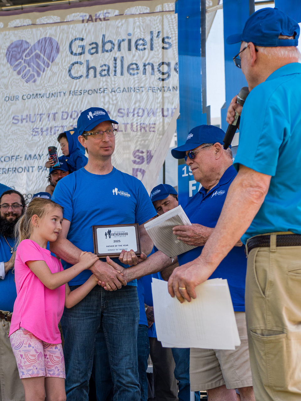 SpoFI Honors Outstanding Fathers at Annual Father's Day Celebration 2 D.J. Merriam receives 2025 Custodial Father of the Year award from SpoFI leadership, accompanied by his daughter at Spokane Father's Day event