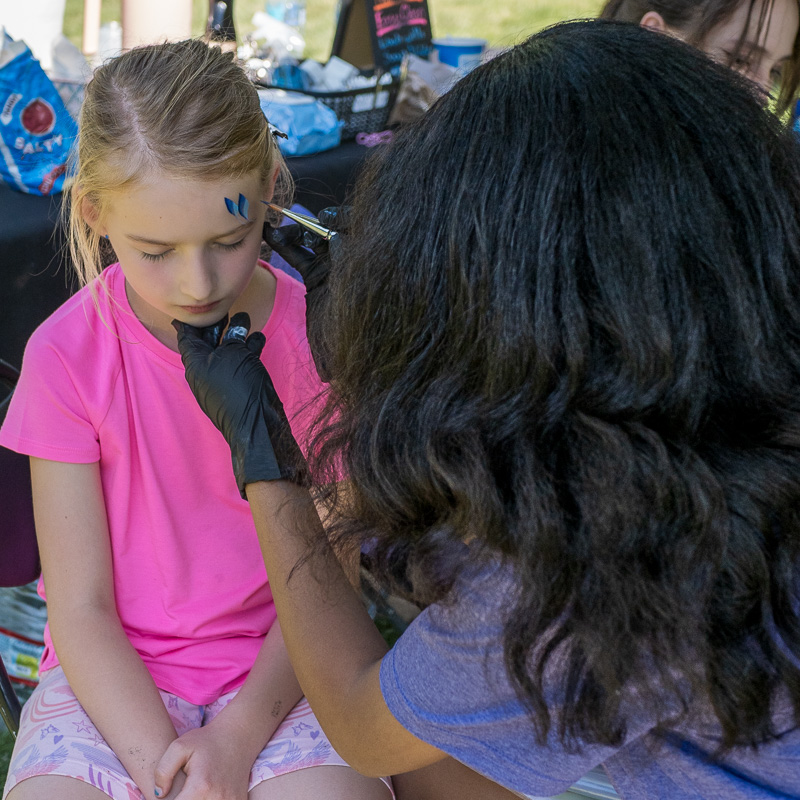 Community connection strengthens Spokane families at Father's Day celebration 6 DJ's daughter patiently awaiting expert face painting by Kitara's talented daughter Leilani